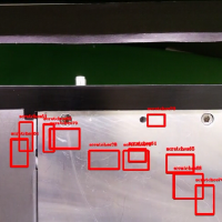 Red bounding boxes highlighting potential defects on a metallic machinery surface.